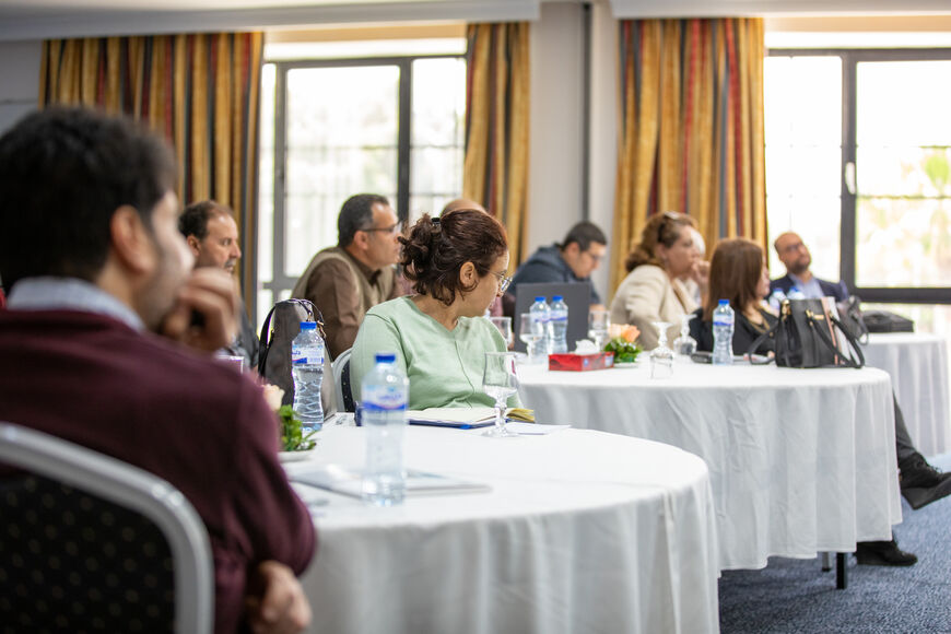 A group during a training sits around tables 