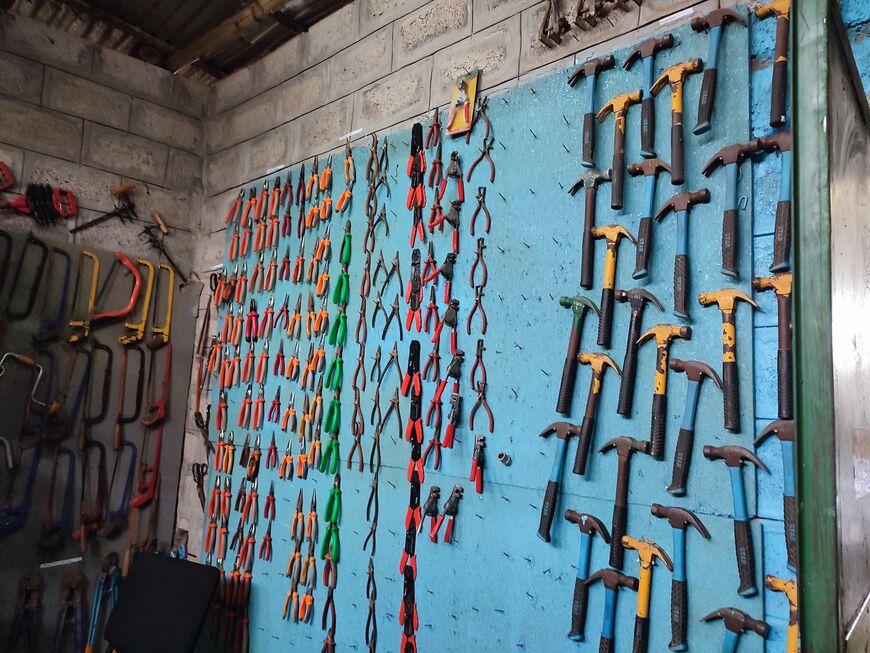 Tools, hammers, pliers, saws hung and sorted on a wall